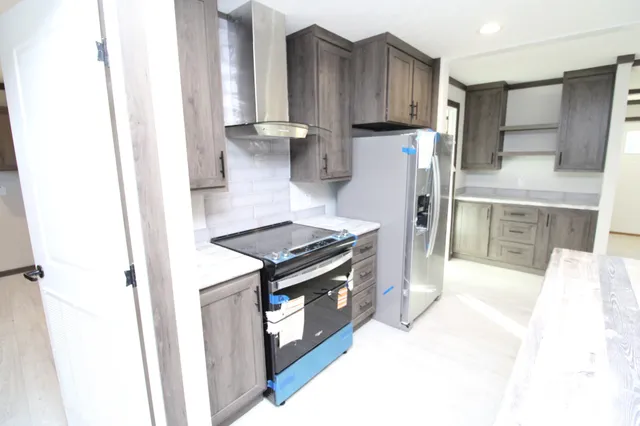 a kitchen with a stove and a refrigerator