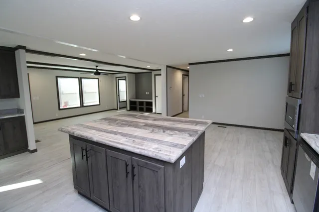 a kitchen with kitchen island a sink stove and refrigerator