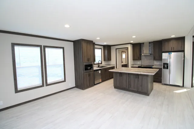 a kitchen with a refrigerator and a stove top oven