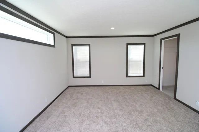 an empty room with windows and closet