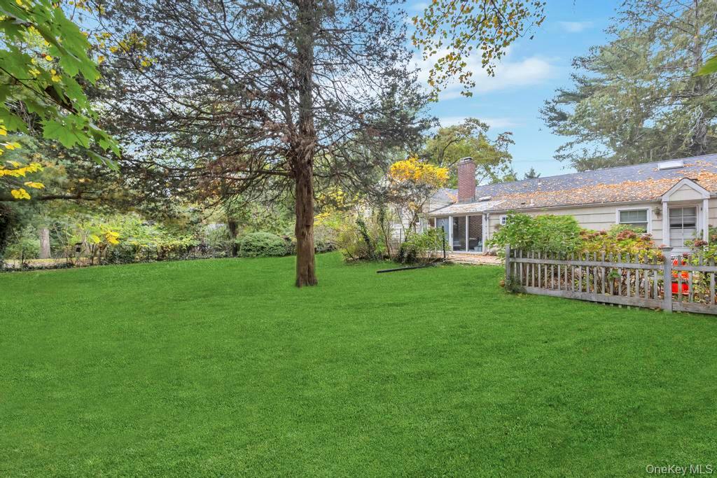 89 Van Brunt Manor Road Setauket, NY 11733 - Photo 12 of 41 a view of a house with a small yard and a tree