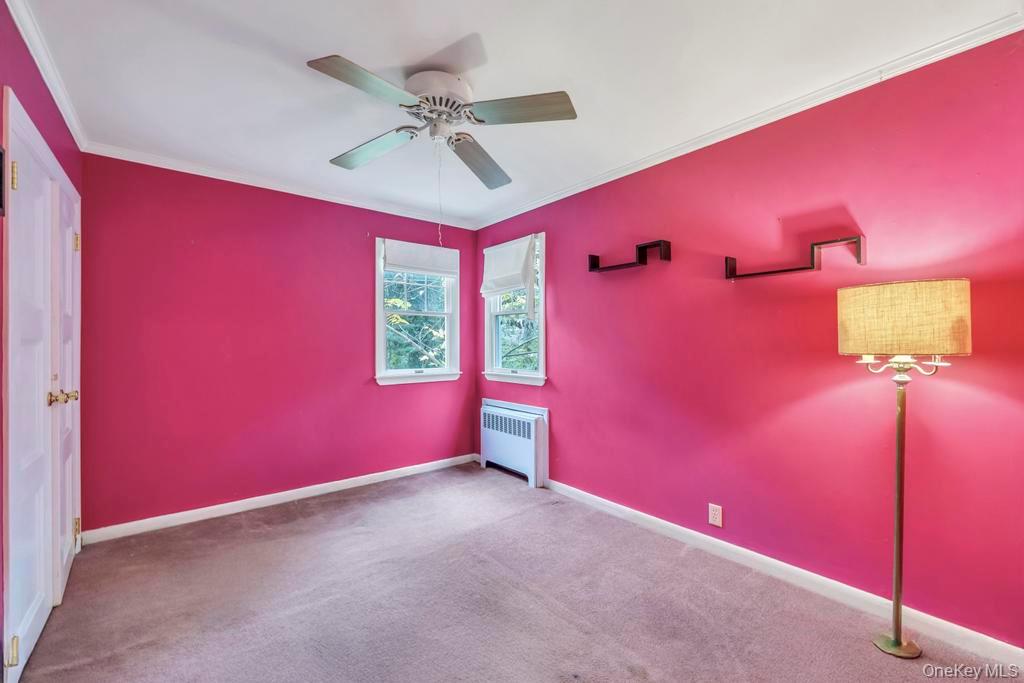 89 Van Brunt Manor Road Setauket, NY 11733 - Photo 21 of 41 a view of a livingroom with a red ceiling fan and window