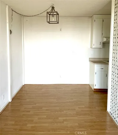 a view of kitchen and empty room