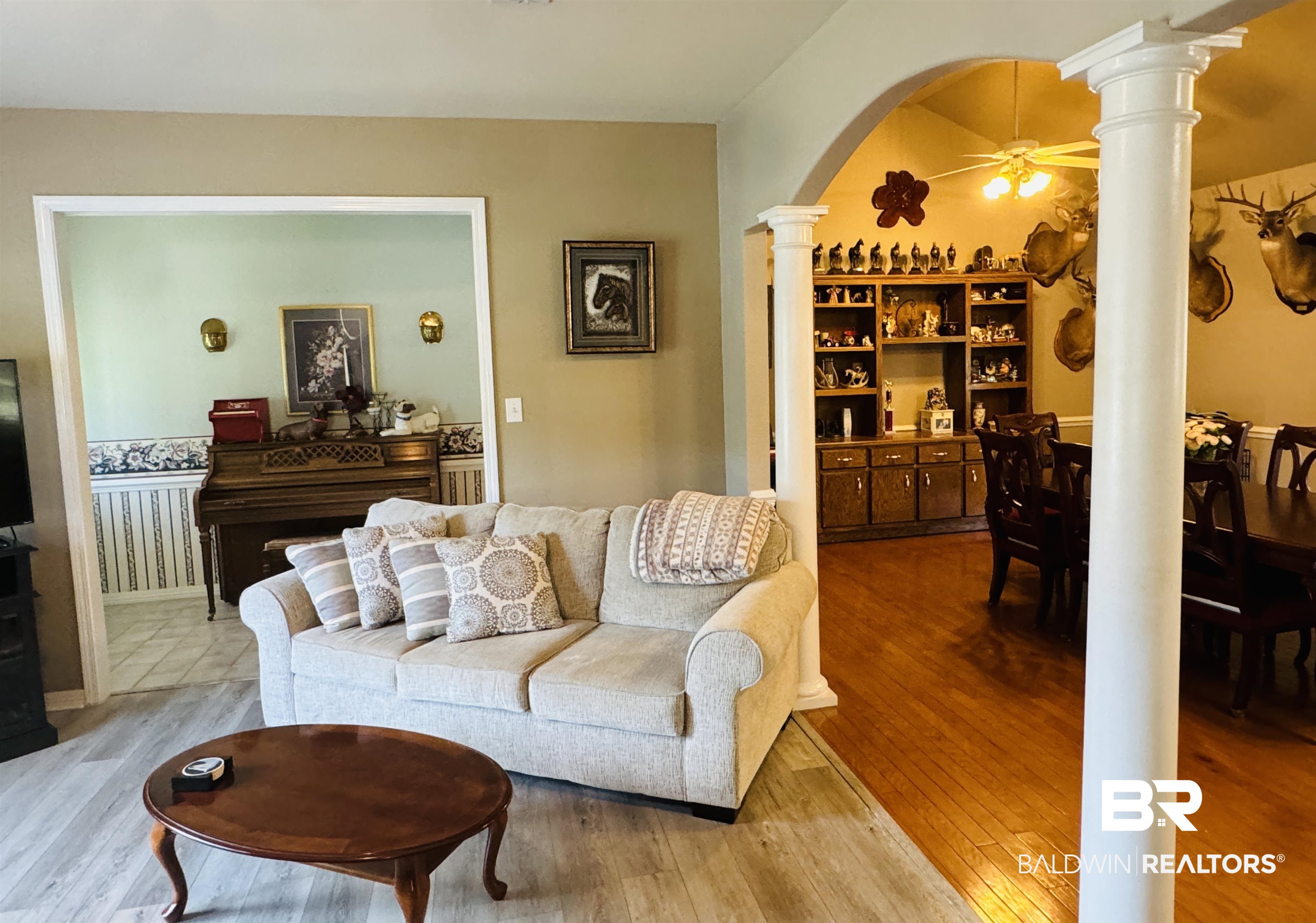 13795 White Road Silverhill, AL 36576 - Photo 19 of 99 Living area with ornate columns, a ceiling fan, arched walkways, and light wood-style floors