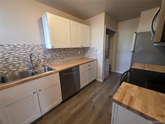 a kitchen with a sink and a refrigerator