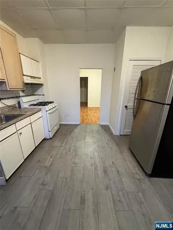 a kitchen with a refrigerator and a stove