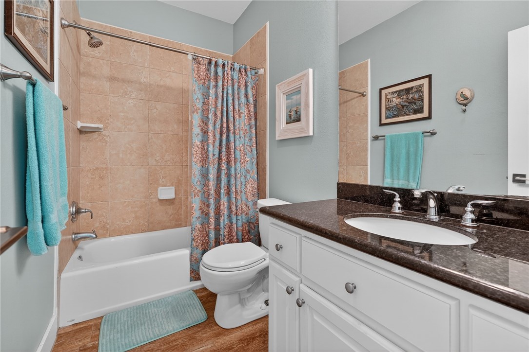 838 Rattlesnake Point Road Rockport, TX 78382 - Photo 20 of 40 a bathroom with a granite countertop sink toilet and shower