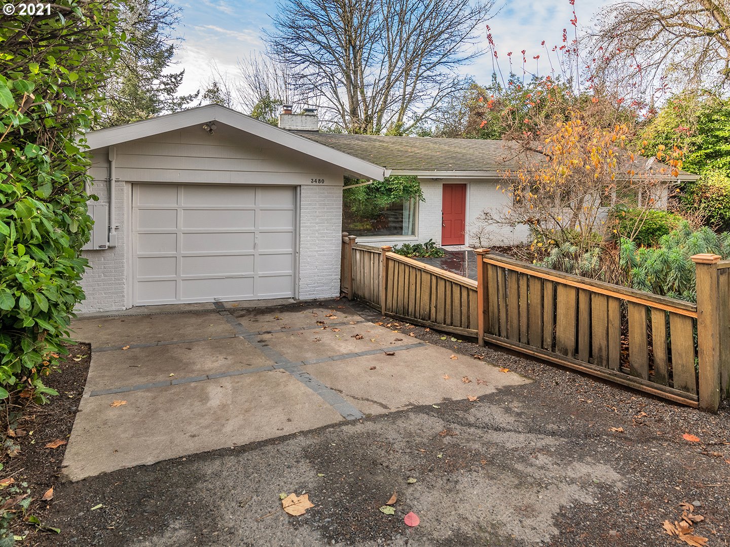 3480 Southwest Talbot Road Portland, OR 97239 - Photo 3 of 32 a view of a house with wooden fence and a tree