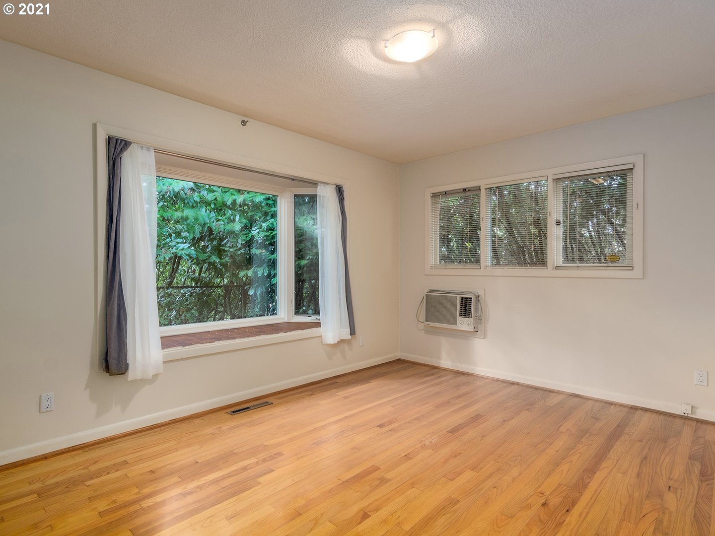 3480 Southwest Talbot Road Portland, OR 97239 - Photo 22 of 32 a view of empty room with wooden floor and fan