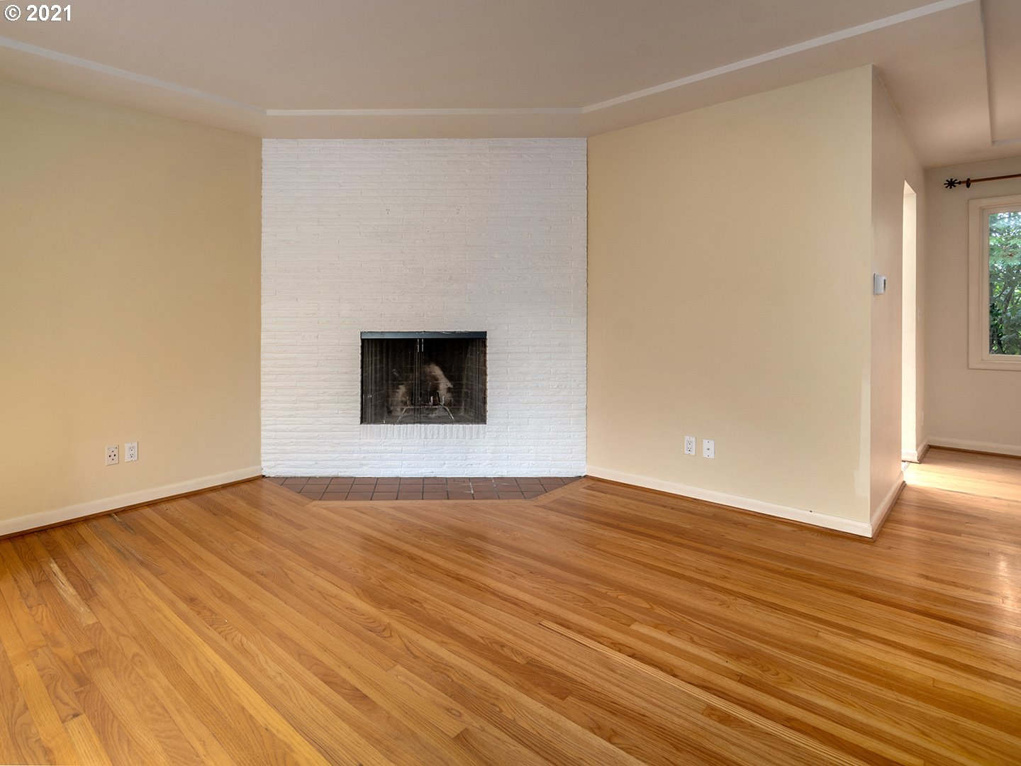 3480 Southwest Talbot Road Portland, OR 97239 - Photo 7 of 32 a view of an empty room with wooden floor and a window