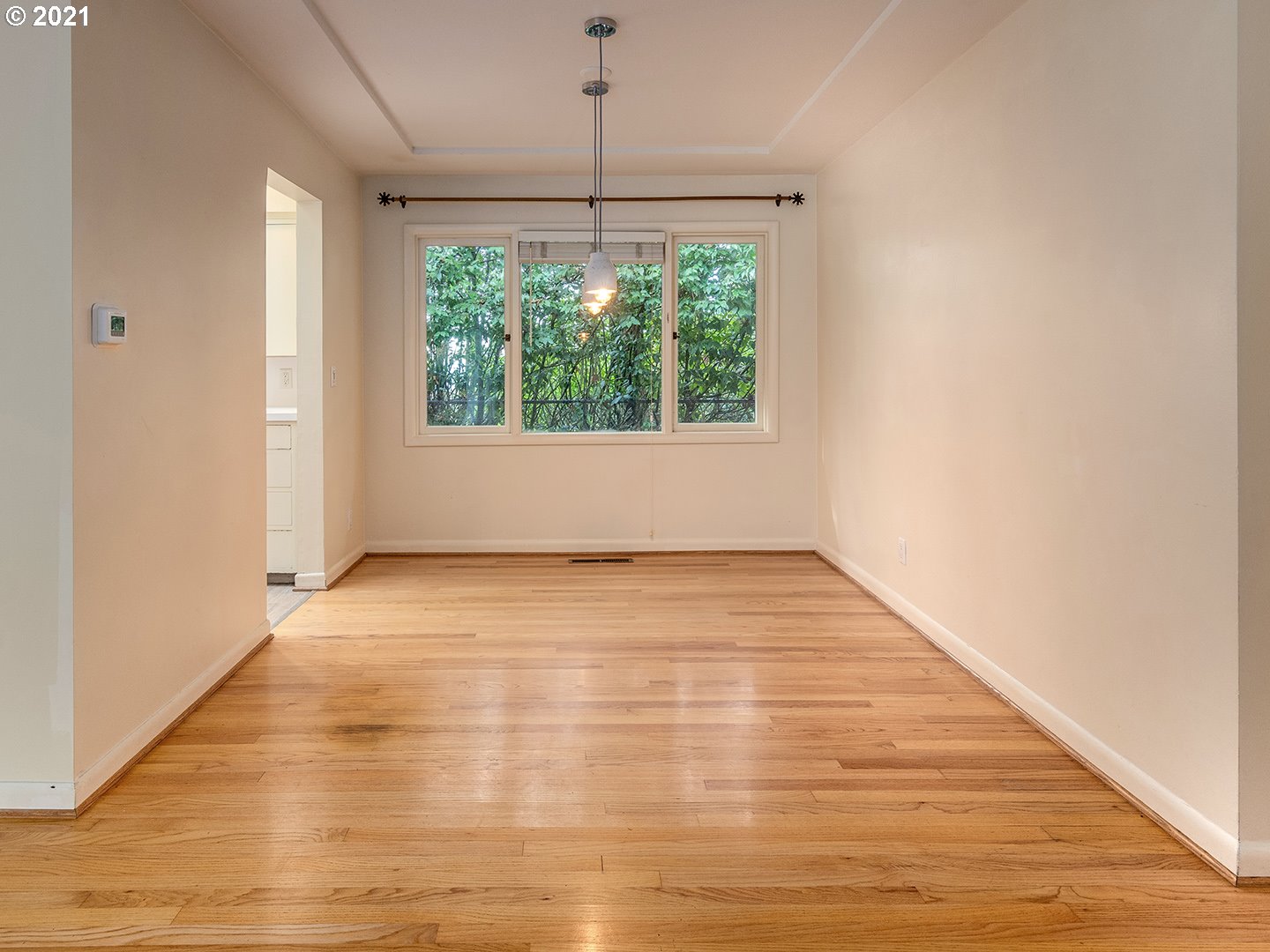 3480 Southwest Talbot Road Portland, OR 97239 - Photo 8 of 32 a view of an empty room with wooden floor and a window