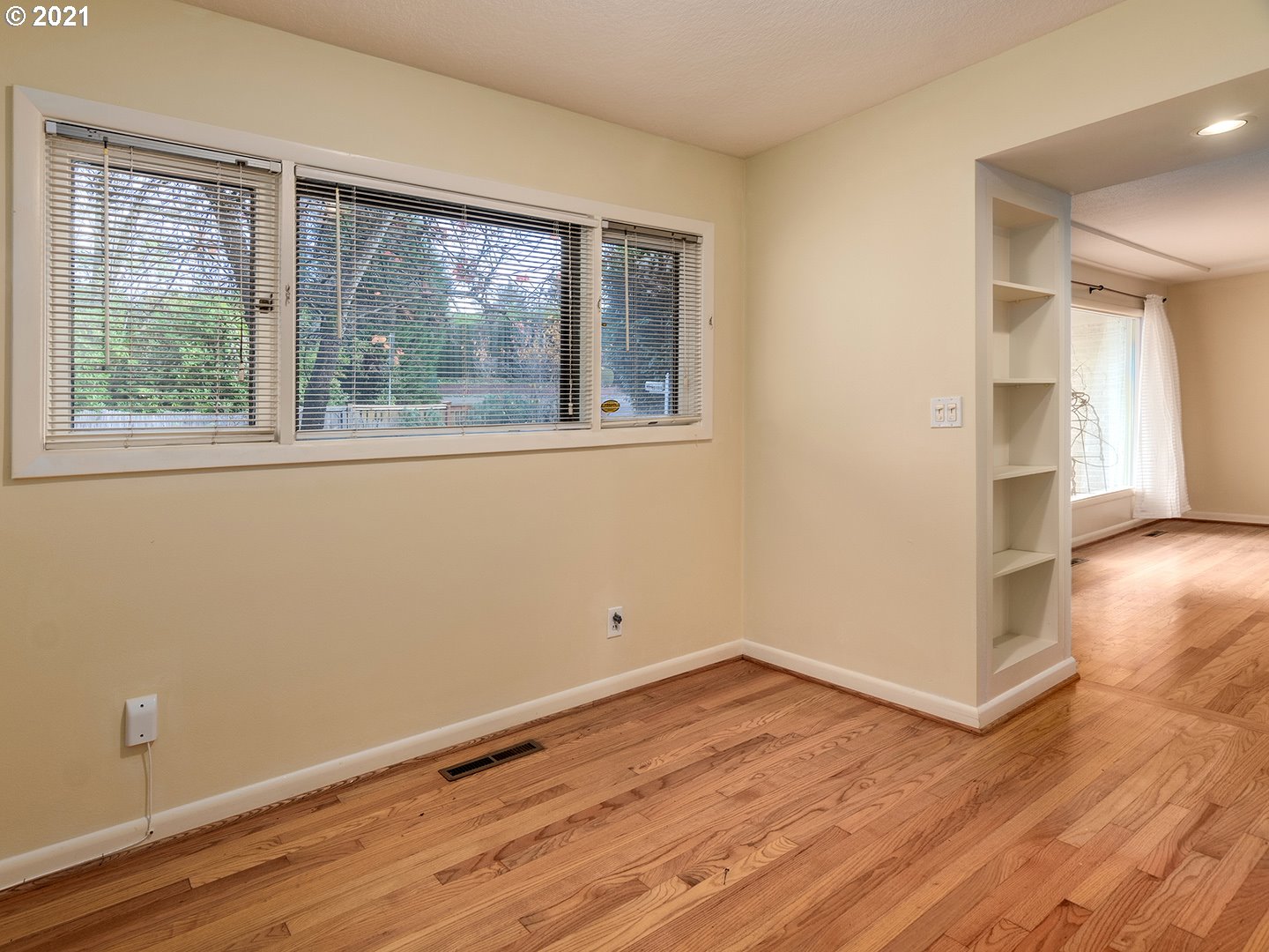 3480 Southwest Talbot Road Portland, OR 97239 - Photo 10 of 32 a view of empty room with wooden floor and fan