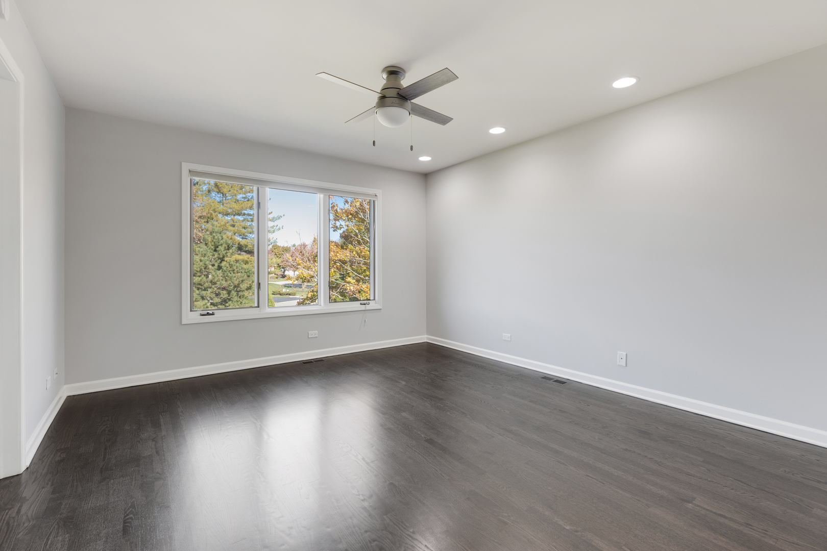 4469 Kettering Drive Long Grove, IL 60047 - Photo 21 of 45 an empty room with wooden floor and windows
