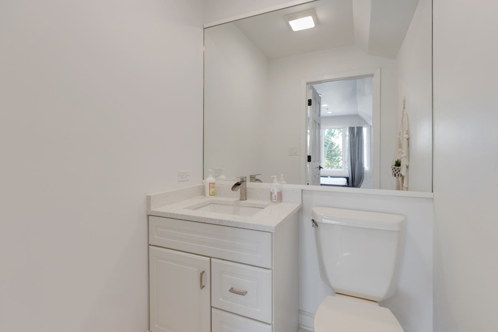 4469 Kettering Drive Long Grove, IL 60047 - Photo 24 of 45 a bathroom with a toilet sink vanity and mirror