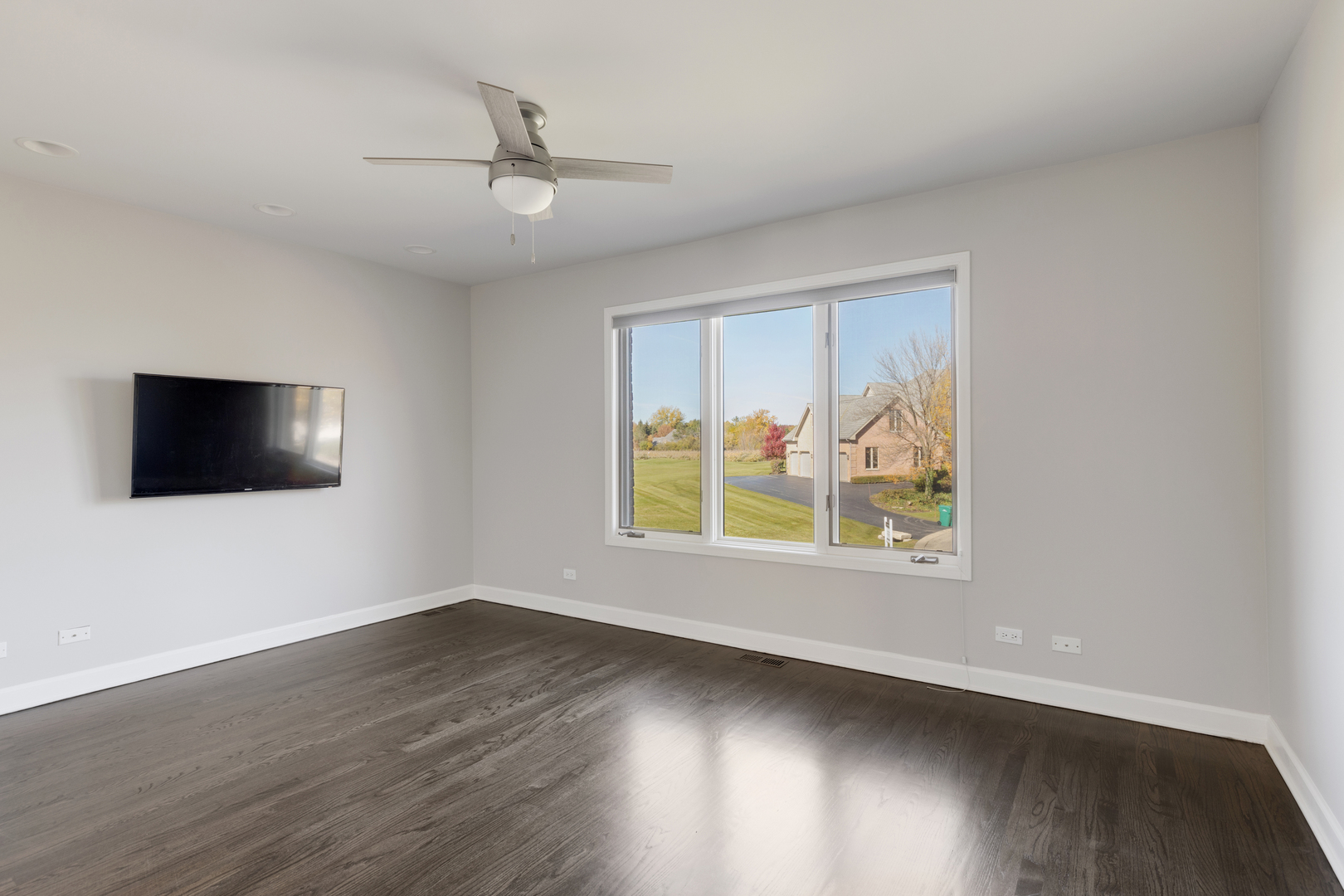 4469 Kettering Drive Long Grove, IL 60047 - Photo 25 of 45 an empty room with wooden floor and windows