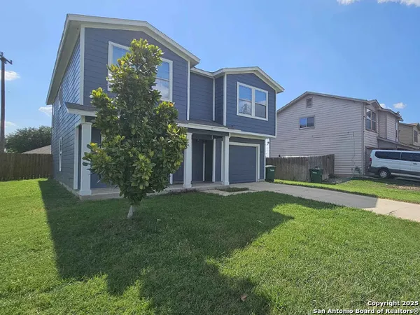 a front view of house with yard and green space
