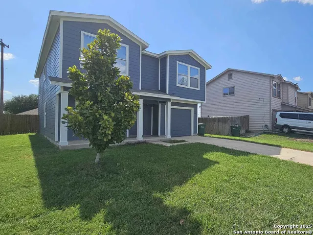 a front view of house with yard and green space