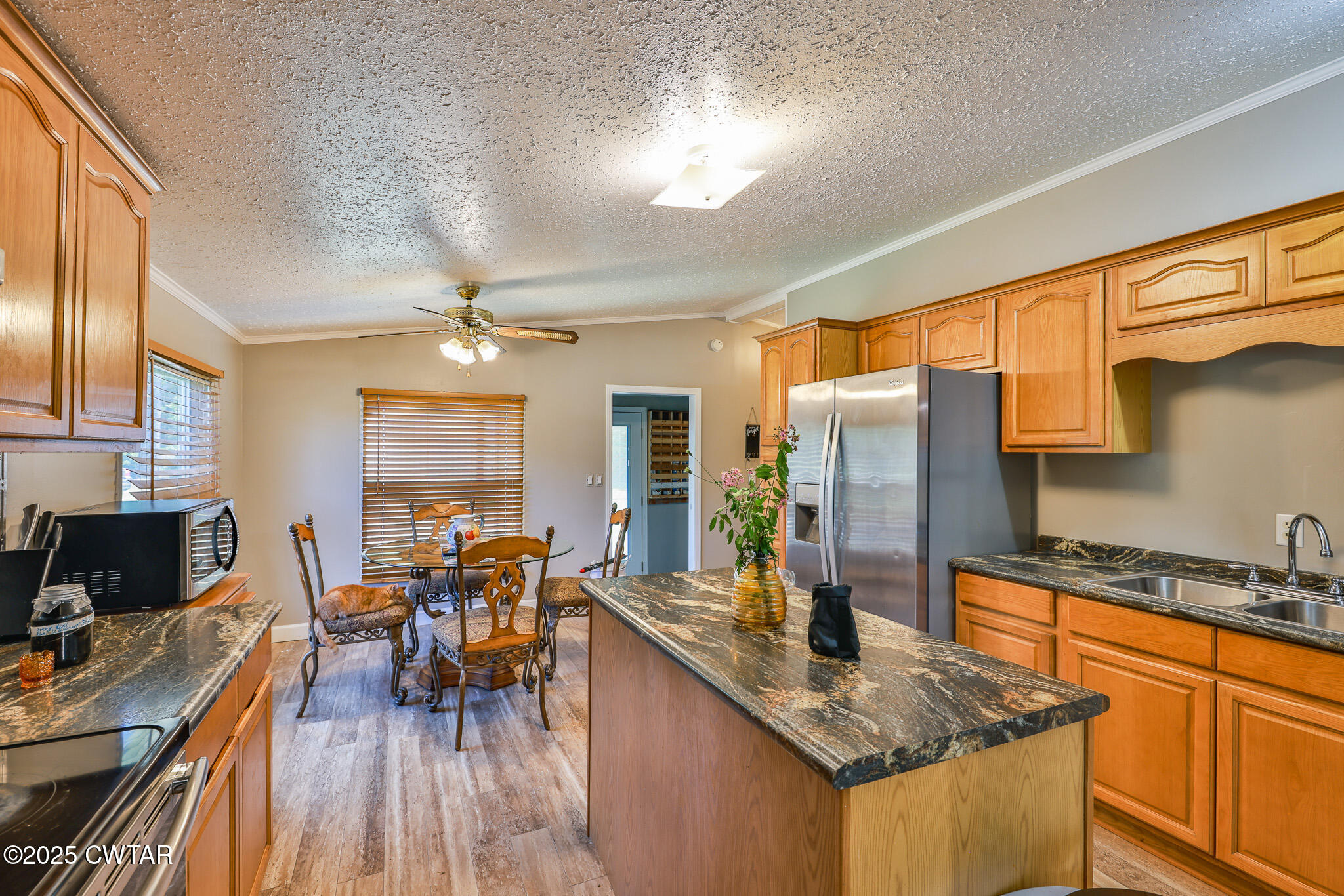 890 Snyder Road Martin, TN 38237 - Photo 13 of 33 a kitchen with stainless steel appliances granite countertop sink stove top oven and cabinets