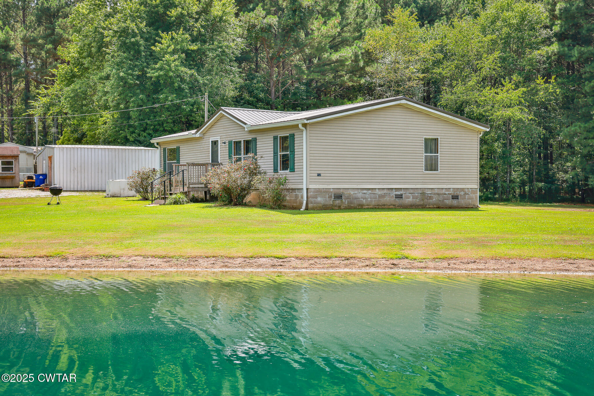 890 Snyder Road Martin, TN 38237 - Photo 10 of 33 a view of an house with swimming pool and a yard