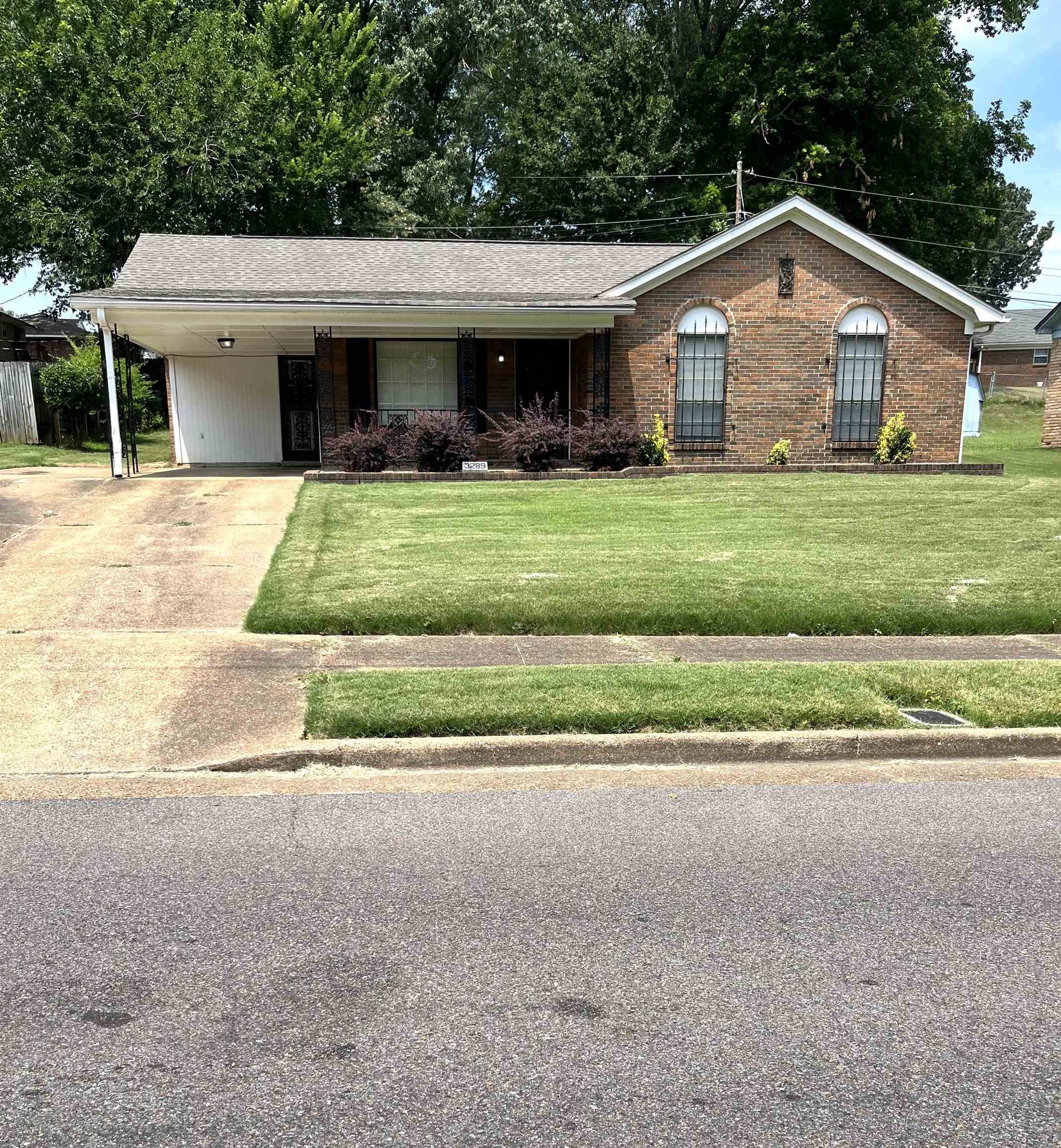 3289 Graves Road Memphis, TN 38116 - Photo 1 of 23 a front view of a house with a yard