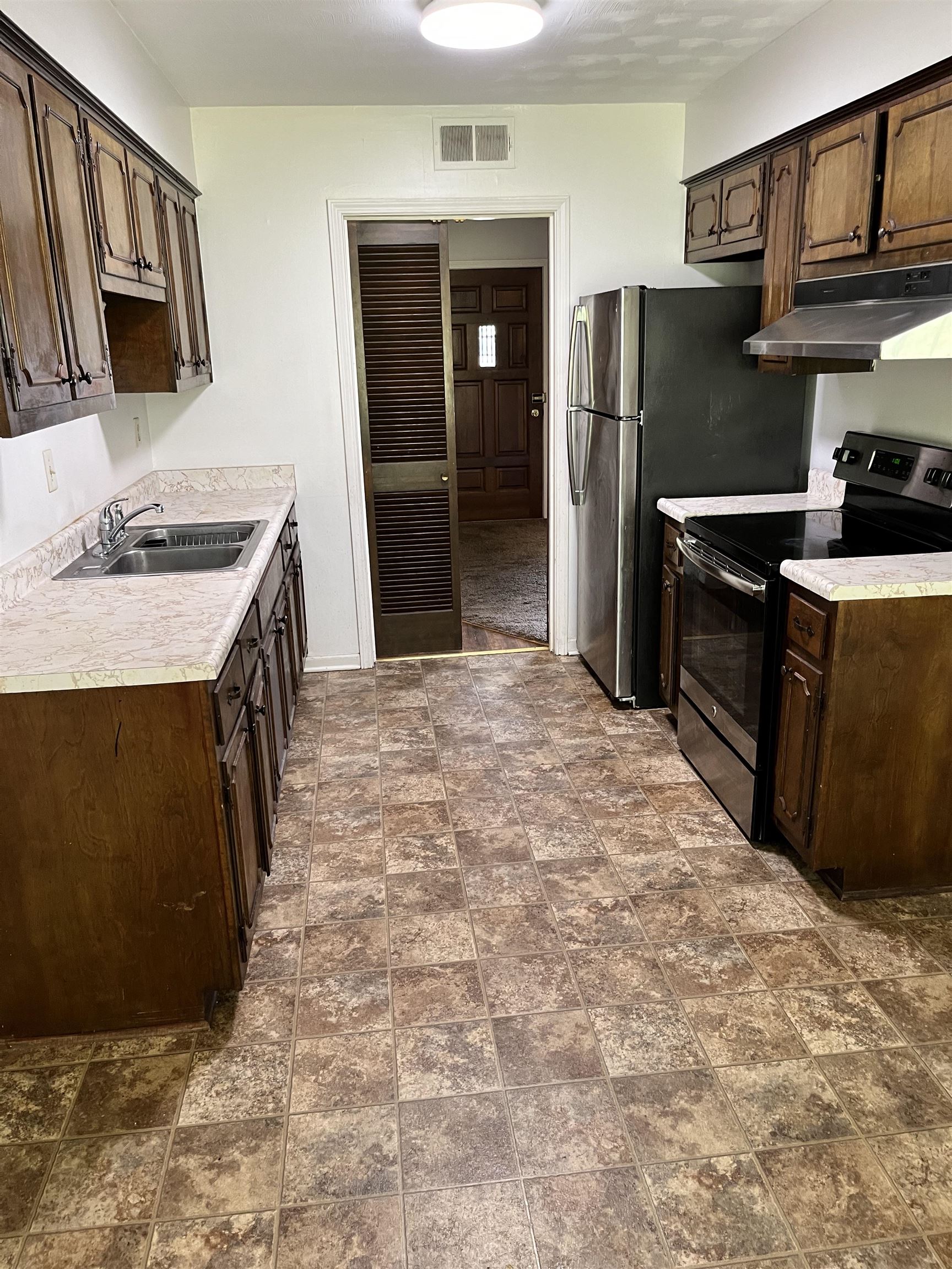 3289 Graves Road Memphis, TN 38116 - Photo 5 of 23 a kitchen with stainless steel appliances granite countertop a refrigerator and a stove