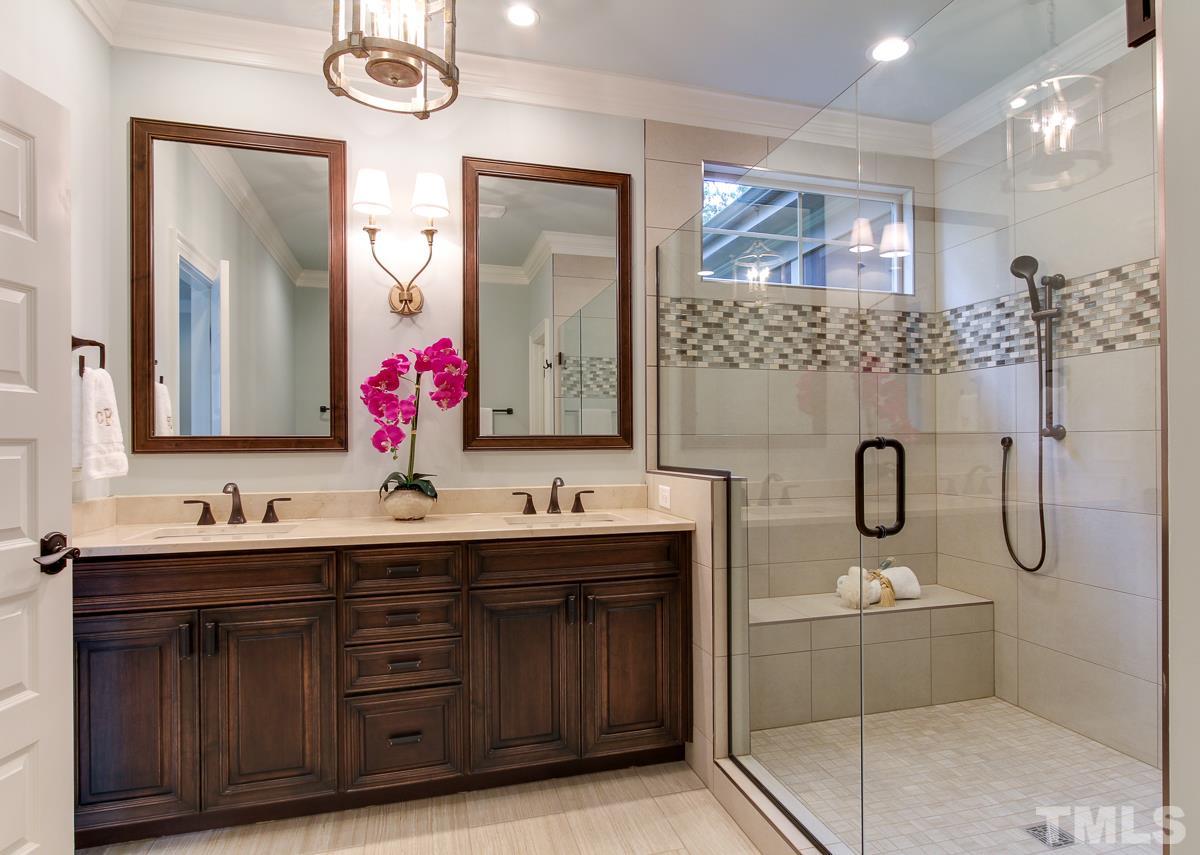 8812 Breeland Way Raleigh, NC 27613 - Photo 13 of 25 a bathroom with a double vanity sink mirror and bathtub