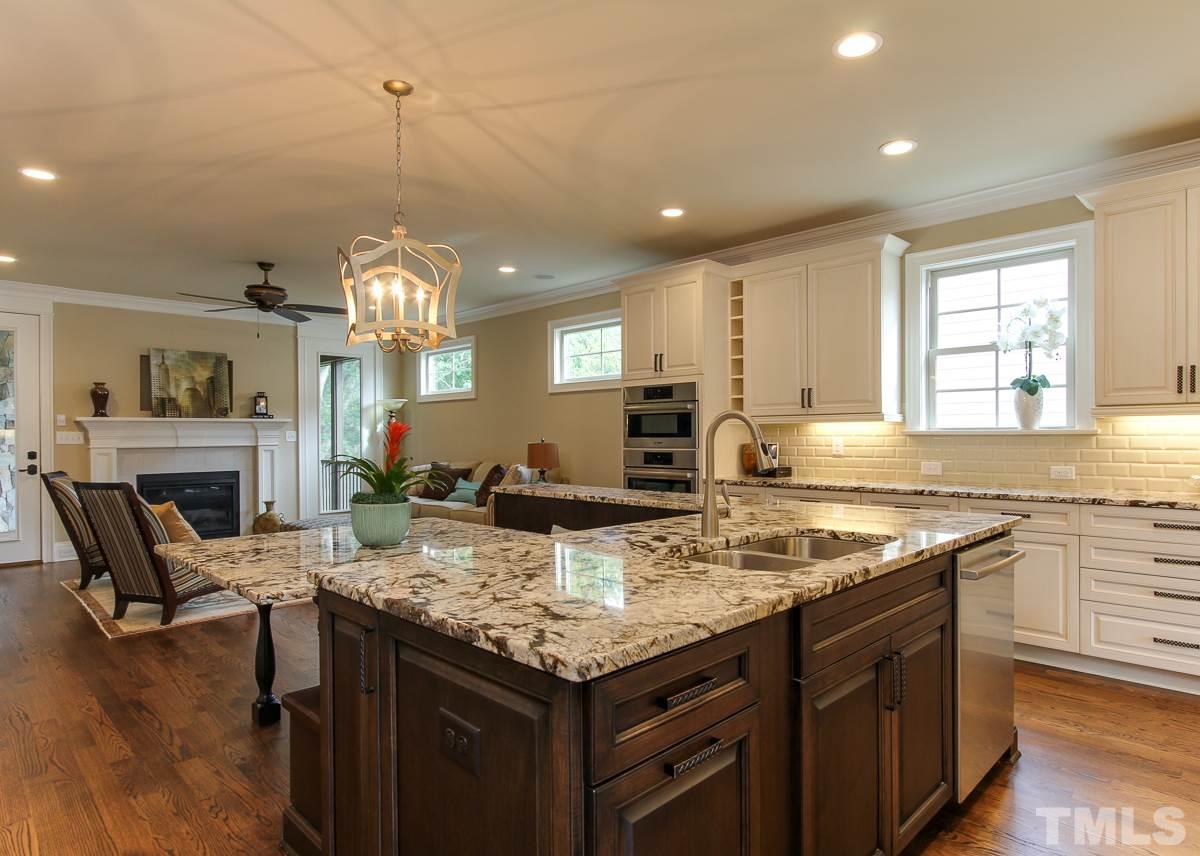 8812 Breeland Way Raleigh, NC 27613 - Photo 5 of 25 a kitchen with a stove cabinets and wooden floor