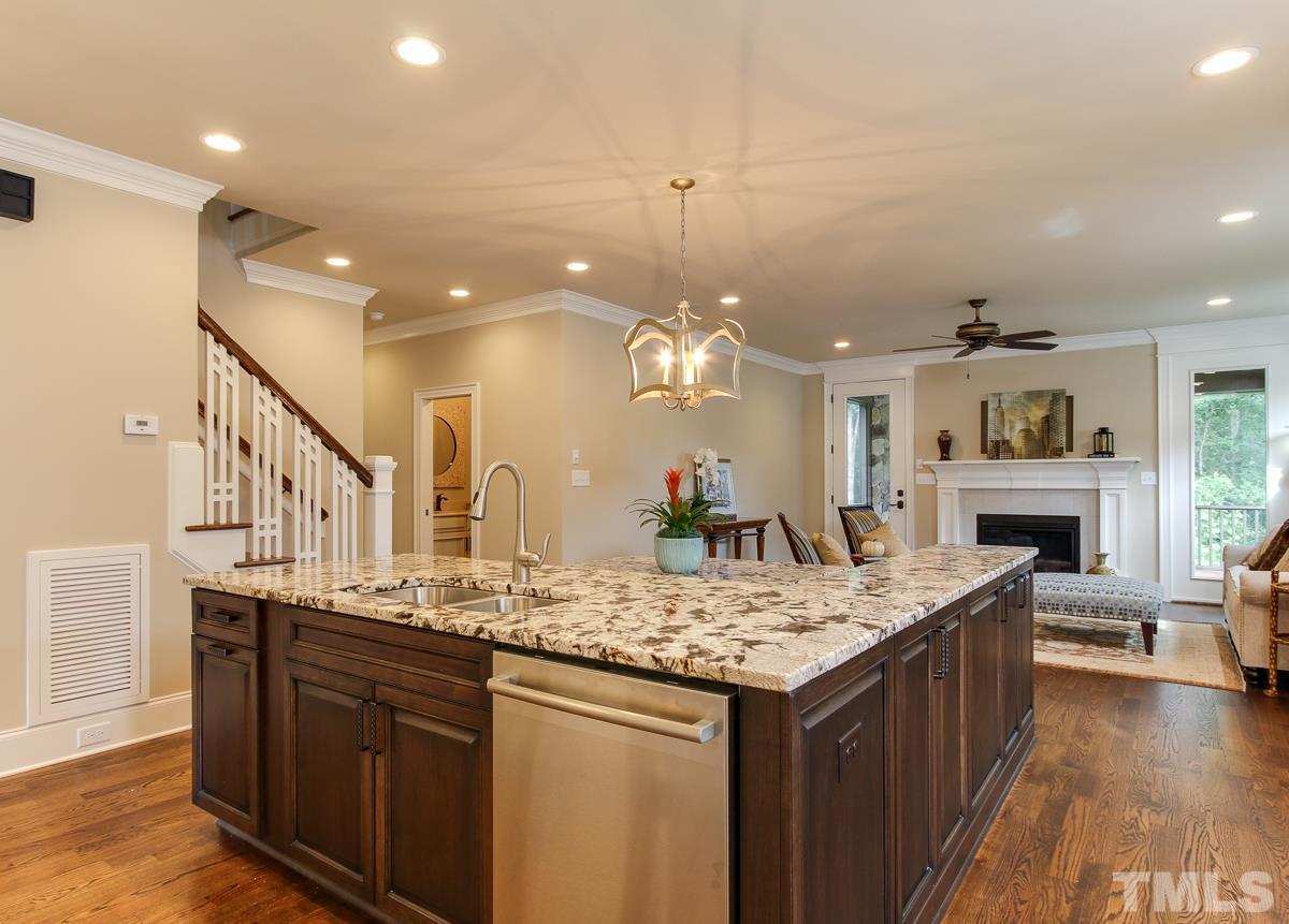8812 Breeland Way Raleigh, NC 27613 - Photo 8 of 25 a kitchen with stainless steel appliances granite countertop a kitchen island a stove and a sink