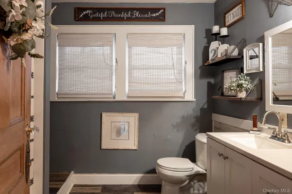 a bathroom with a sink a toilet and a window