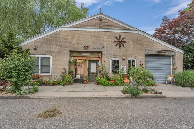 a front view of a house with a yard and a garage