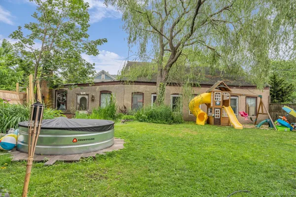 a backyard of a house with lots of green space and plants