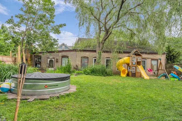 a backyard of a house with lots of green space and plants