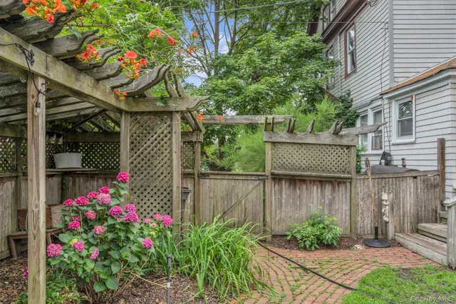 a garden with trees in front of it