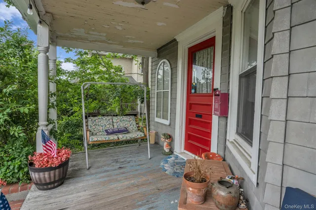 a view of a porch with chairs and backyard