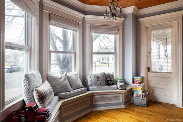 a living room with furniture and a dining table