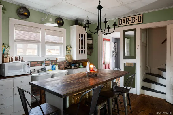 a kitchen with a table chairs and a refrigerator