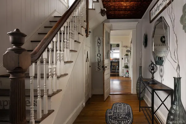 a view of hallway with wooden floor and stairs