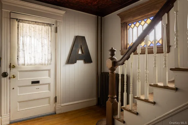a view of staircase with wooden floor and windows