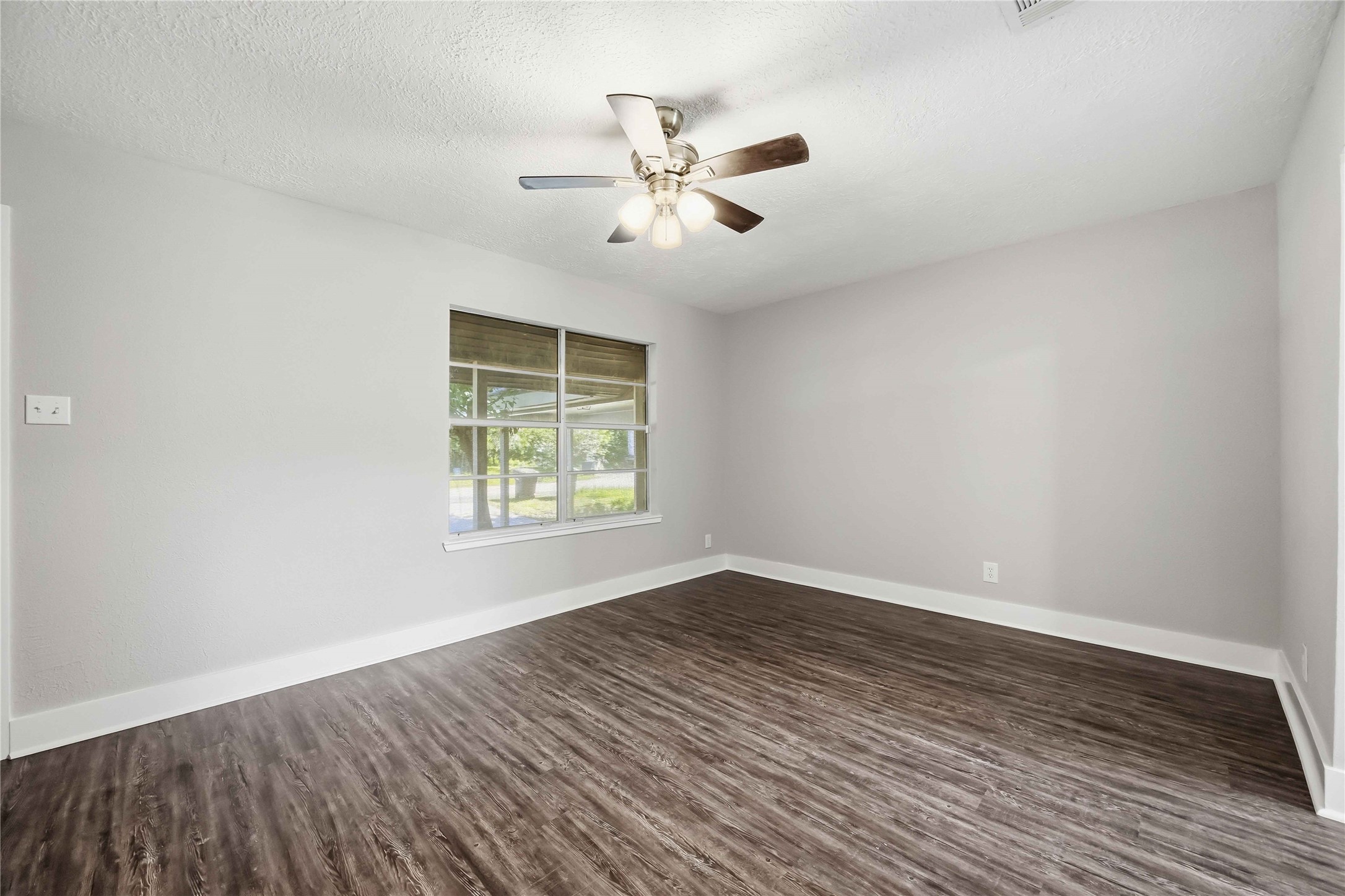 113 East Witcher Lane Houston, TX 77076 - Photo 6 of 21 a view of an empty room with wooden floor and a window