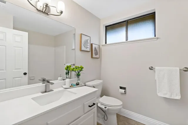 a kitchen with stainless steel appliances white cabinets and a window