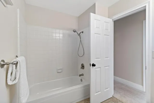 a view of a patio with table and chairs and a large tree