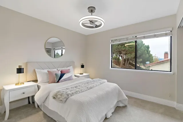 a patio with table and chairs and potted plants