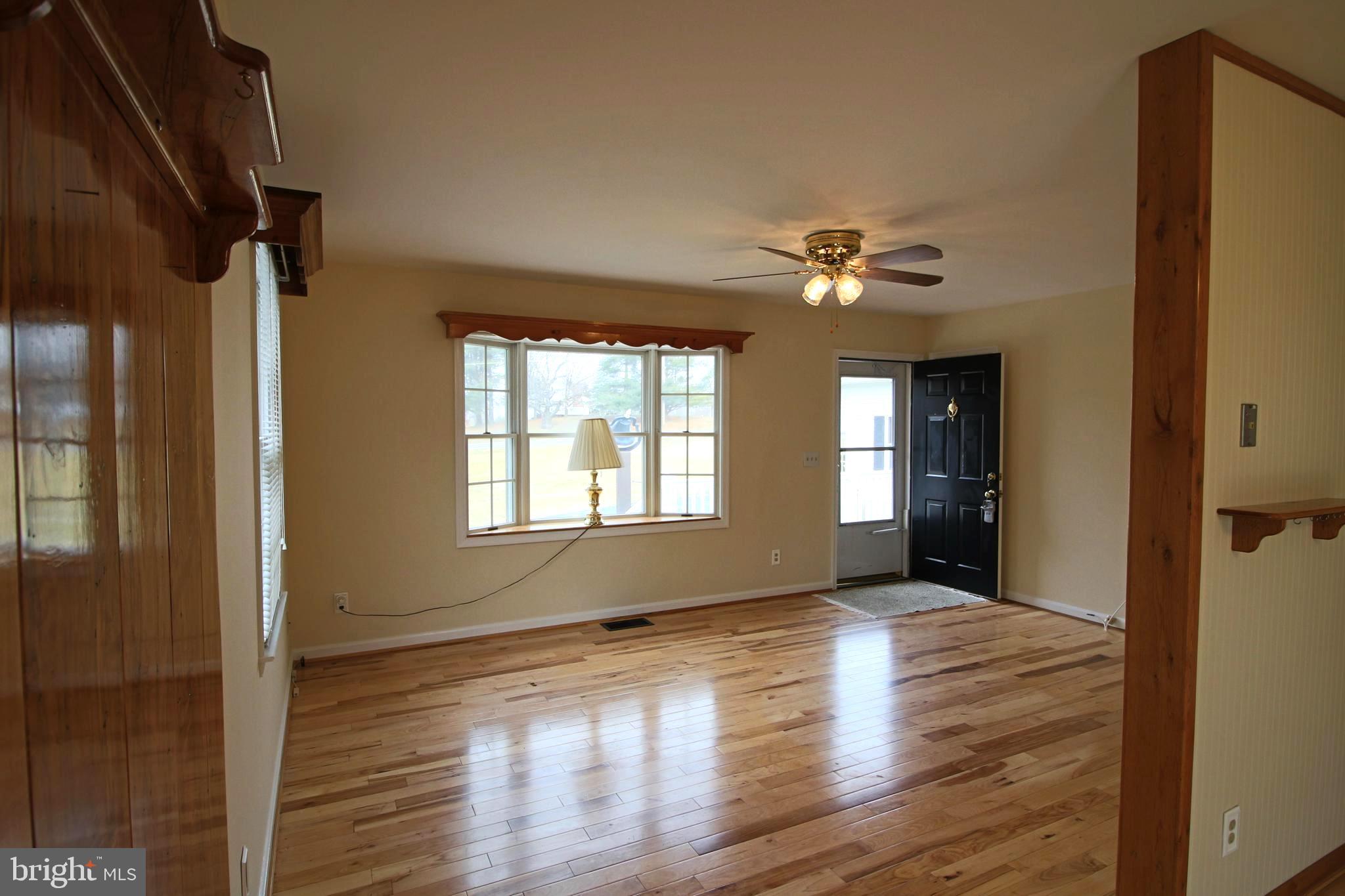 231 Deale Road Tracys Landing, MD 20779 - Photo 7 of 43 a view of an empty room with window and wooden floor