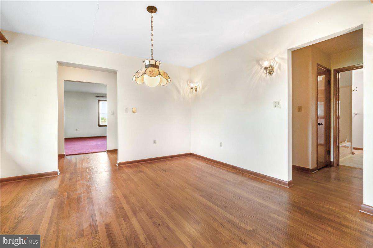 6010 Keysville Road Keymar, MD 21757 - Photo 12 of 64 a view of a room with wooden floor and a chandelier