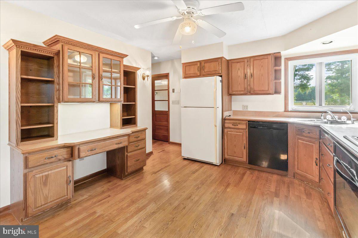 6010 Keysville Road Keymar, MD 21757 - Photo 10 of 64 a kitchen with stainless steel appliances a refrigerator a sink dishwasher a stove and white countertops with wooden floor