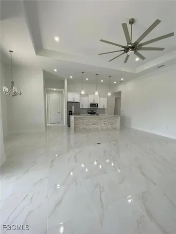 a view of a kitchen with a sink and a refrigerator