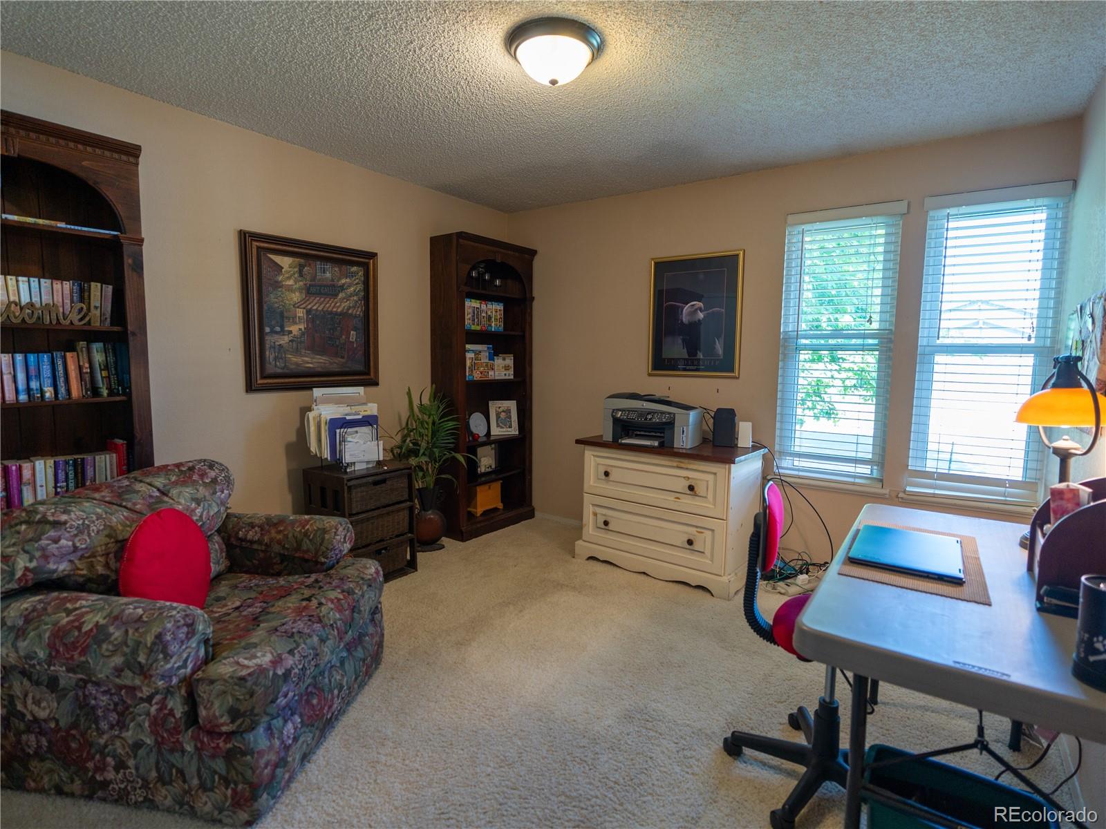 8908 Jellison Court Westminster, CO 80021 - Photo 11 of 17 a living room with furniture and a flat screen tv
