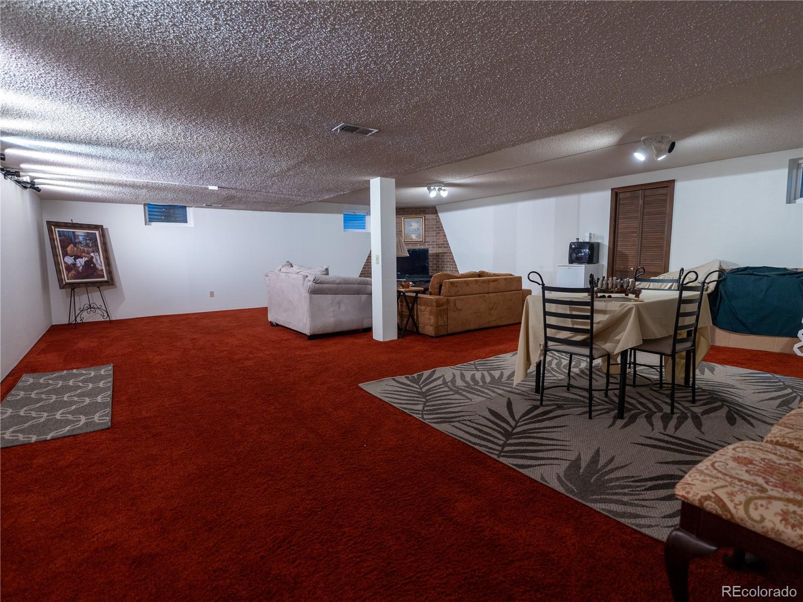 8908 Jellison Court Westminster, CO 80021 - Photo 12 of 17 a livingroom with furniture and dining table