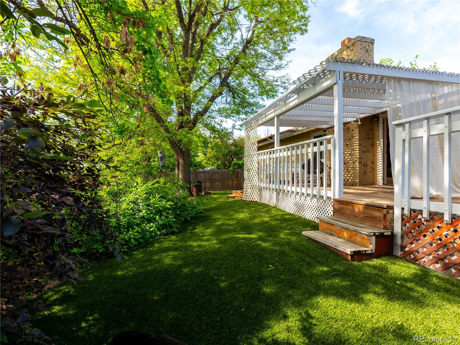 8908 Jellison Court Westminster, CO 80021 - Photo 16 of 17 a view of backyard with a garden and deck