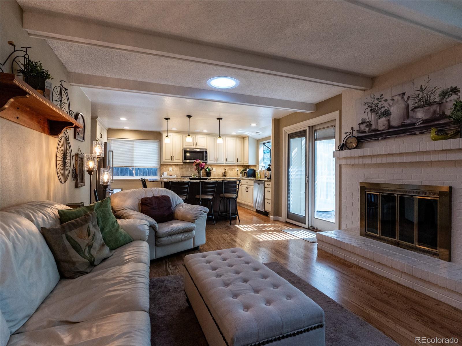 8908 Jellison Court Westminster, CO 80021 - Photo 2 of 17 a living room with furniture and a fireplace